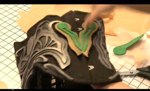 Yaya using Worbla (tan) and craft foam (green) to mold the shapes for her Dark Elf costume.